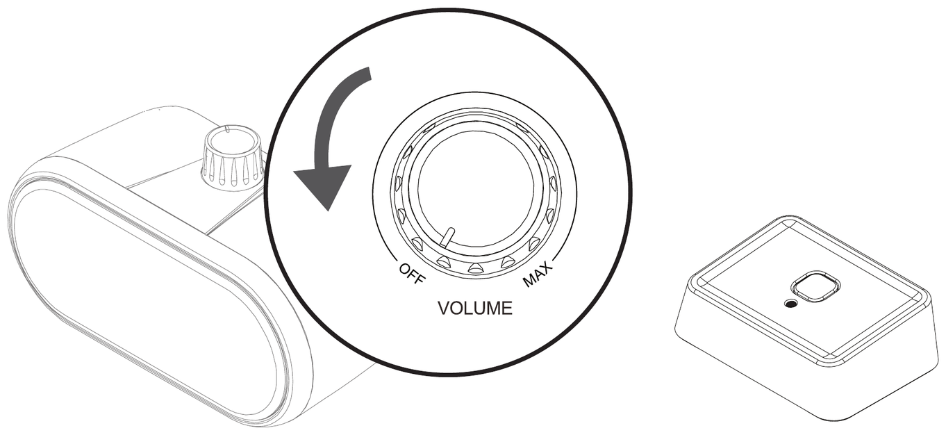 Close-up of the speaker's power and volume knob being turned counterclockwise toward OFF, next to the transmitter.
